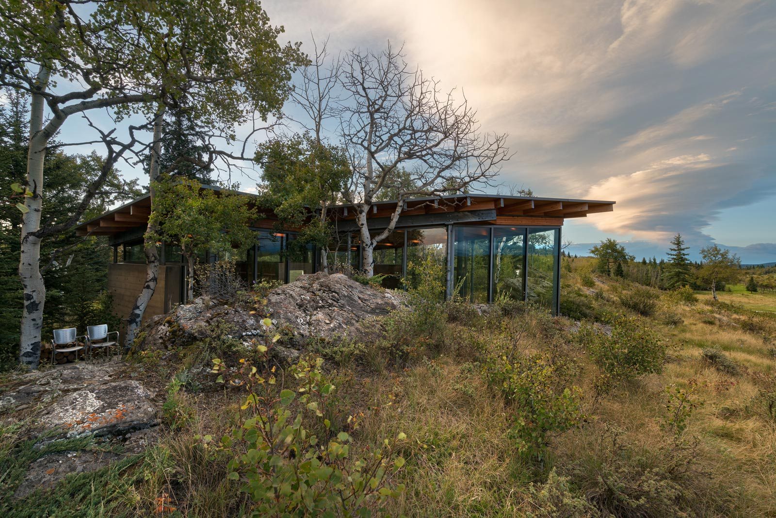 Rock House design is crafted to blend into the sandstone outcroppings and grassy hill below